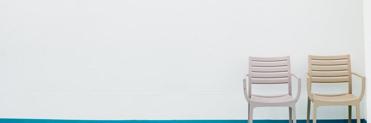 two chairs sitting next to each other on a blue floor